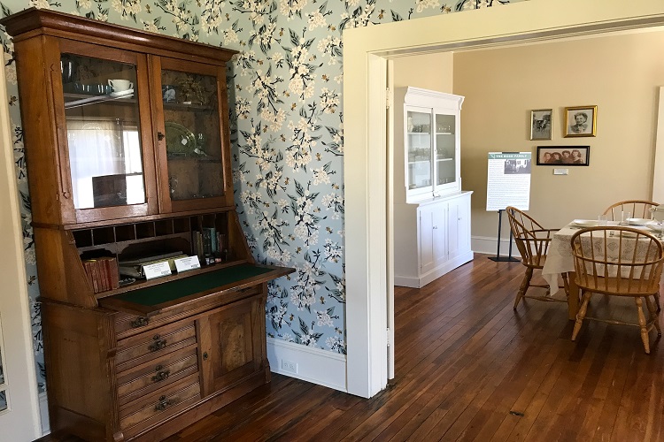 a dining room with a china cabinet and a dining room table.